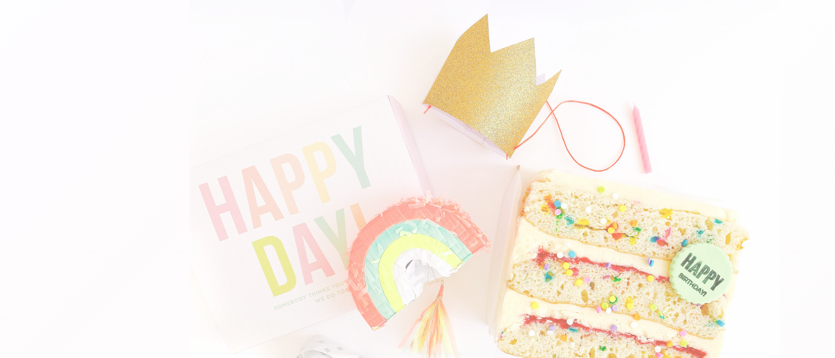 Colorful birthday-themed items including a cake, crown, and 'Happy Day' sign on a white background.