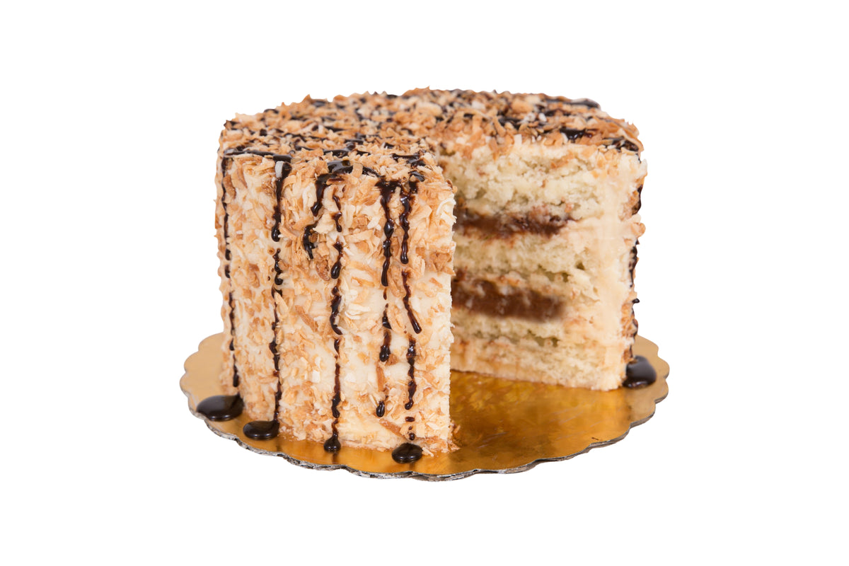 Sift Samoa coconut cake with caramel buttercream, chocolate ganache and toasted coconut